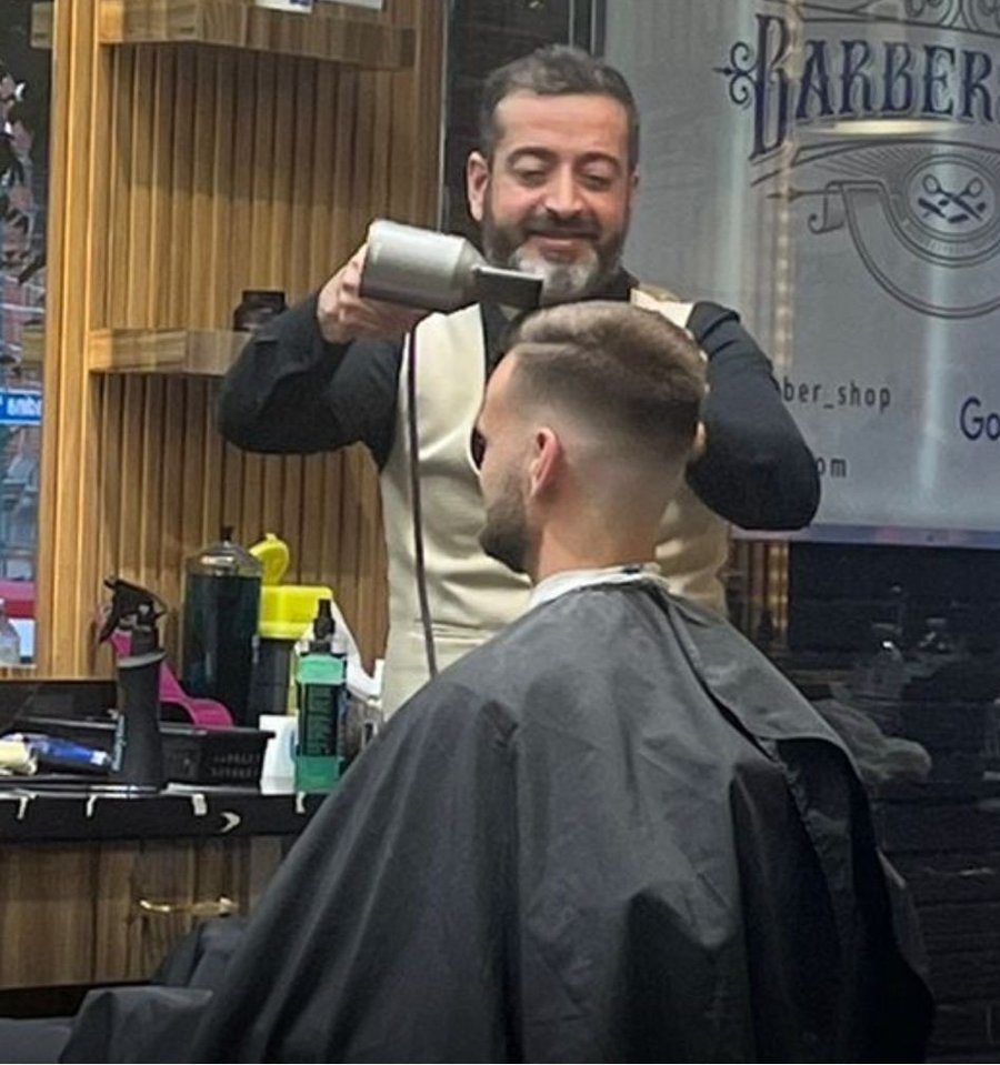 Nasim cutting a client's hair at his Toronto barbershop