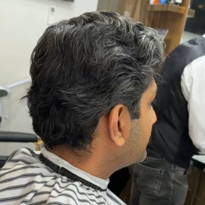 Client with fresh cut and cape at Nasim Barbershop